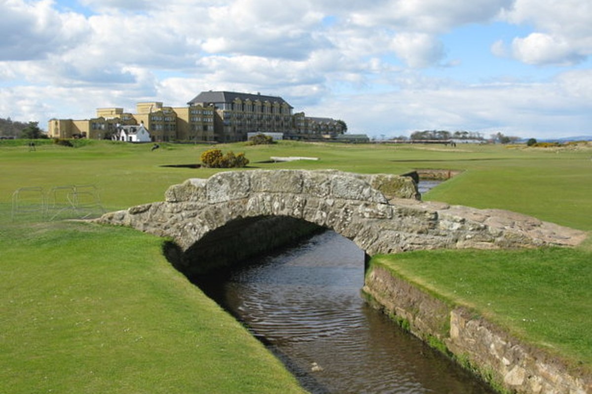 Historical April 10, 2017 view of Swilken Bridge across the burn on the Old Course at St Andrews, with golf links and the hotel in the background.