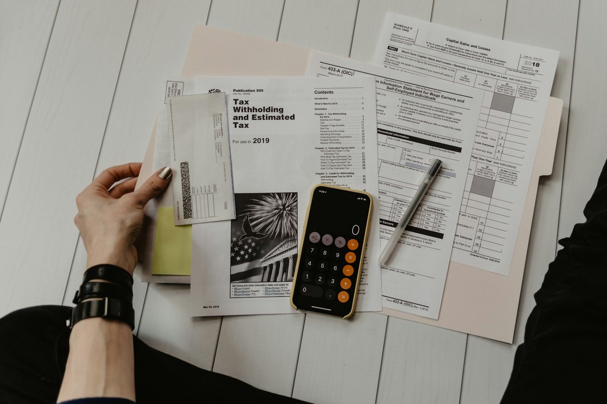 How to Report Kalshi Winnings and Losses on Your Tax Return - tax forms calculator desk (photo 1)